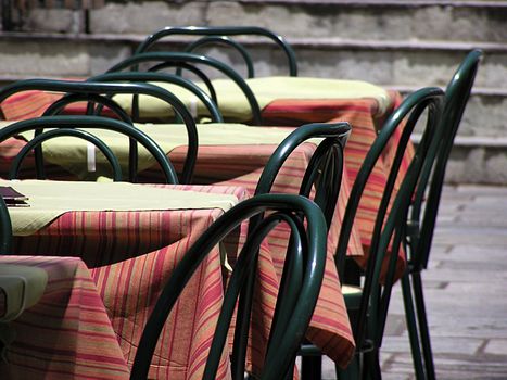 Empty restaurant tables on the sun.