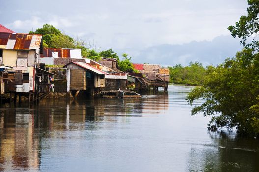 Houses slowly invading a mangrove forest in the Philippines