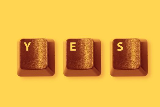 Red computer keys spelling "YES", on yellow background