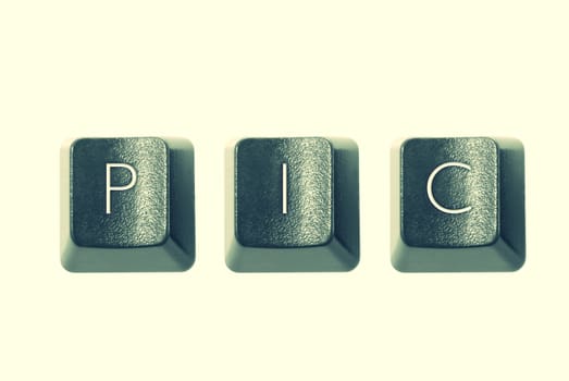 Cross-processed computer keys, spelling "PIC"
