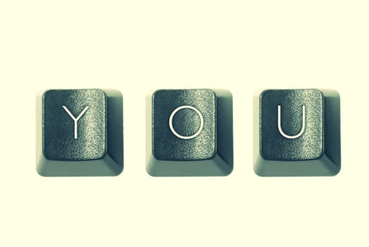 Cross-processed computer keys, spelling "YOU"