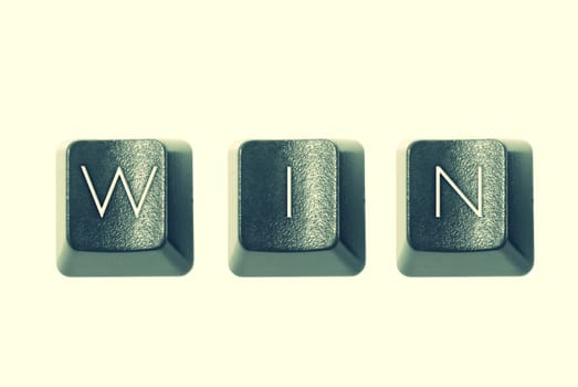 Cross-processed computer keys spelling "WIN"