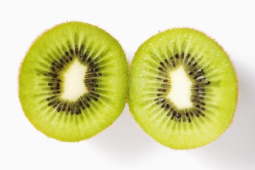 Cross-section of sliced kiwi fruit on white background