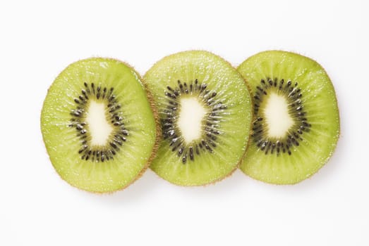 Three slices of kiwi fruit on white background
