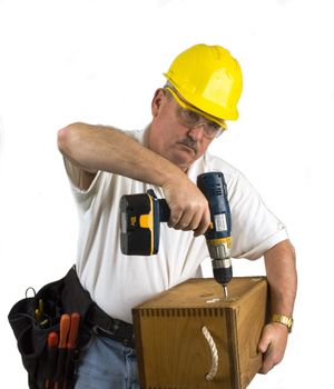 Carpenter using nail gun to repair box