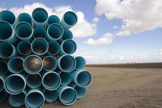 Agricultural irrigation piping stacked on farm