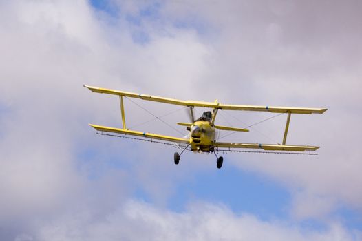 Aircraft-Crop duster spraying fields with chemical insecticides to prevent spoilage