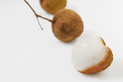Line of Lychees on white background