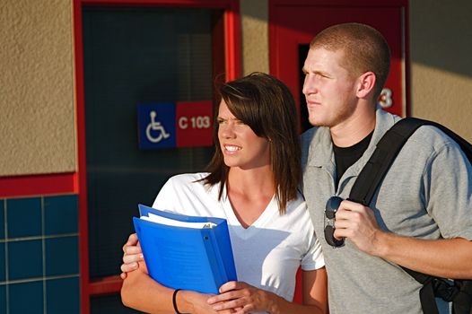 Young college students outside of a classroom at a public university