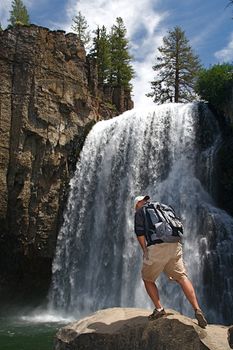 Rugged hiker views the wild terrain at Rainbow Falls in the Devils Postpile NM