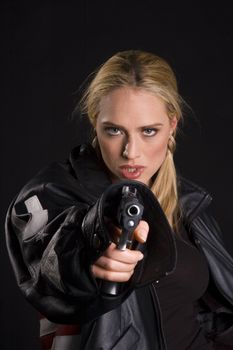 Sexy blond in leather jacket and semi-automatic handgun with magazine removed