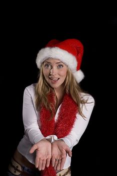 A attractive woman in santa hat and red boa over a black background