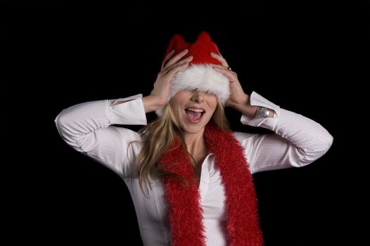 A woman in a santa hat and a red boa over a black background