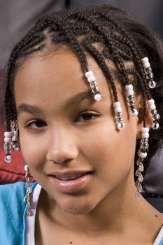 cute young smiling african american girl with hair in braids and beads