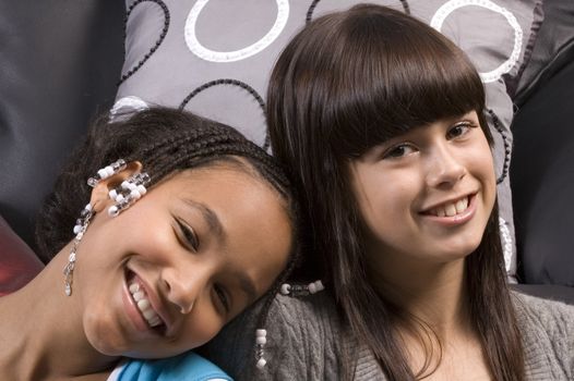 cute african american girl resting head on the shoulder of caucasian girl freind