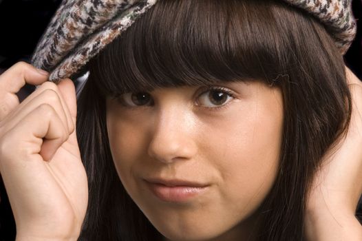 closeup of a cute young girl wearing a golfers hat