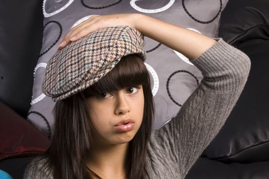 closeup of a cute young girl wearing a golfers hat