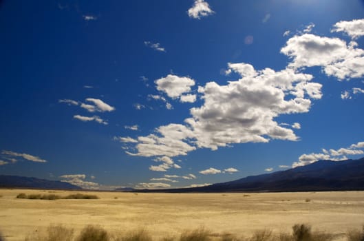 clouds over death valley with a little flare from the sun for effect