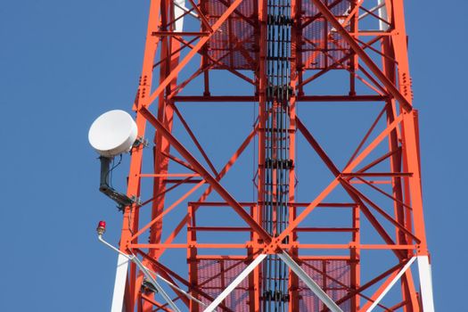 Mobile phone communication repeater antenna tower in blue sky