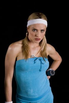 Woman exercising with weights against a black background