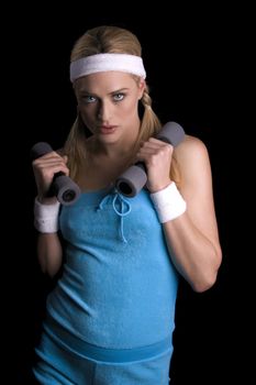 Woman exercising with weights over a black background