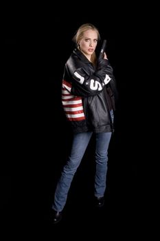 Woman in a leather jacket with USA flag on back, USA on arms and a gun in her hand