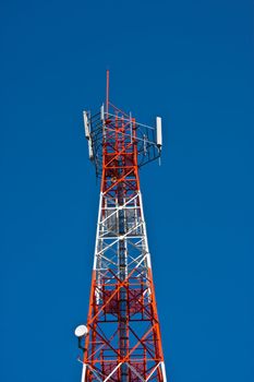 Mobile phone communication repeater antenna tower in blue sky