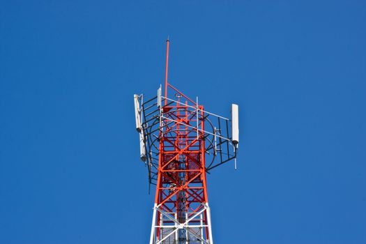 Mobile phone communication repeater antenna tower in blue sky