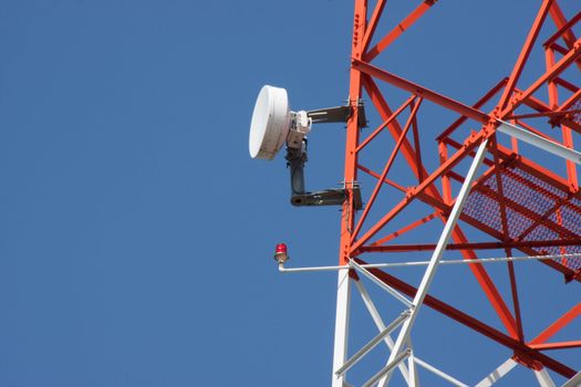 Mobile phone communication repeater antenna tower in blue sky