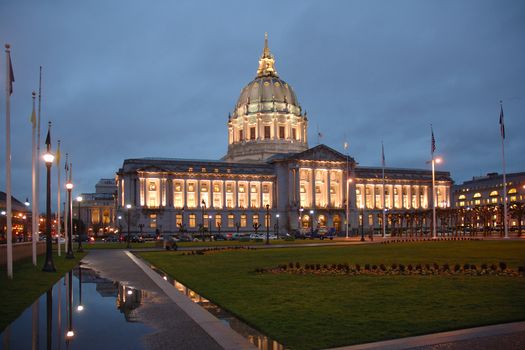 San Francisco Civic Center illuminated at night.with a reflection after a rain