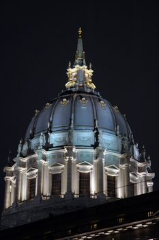 San Francisco Civic Center illuminated at night.with a reflection after a rain