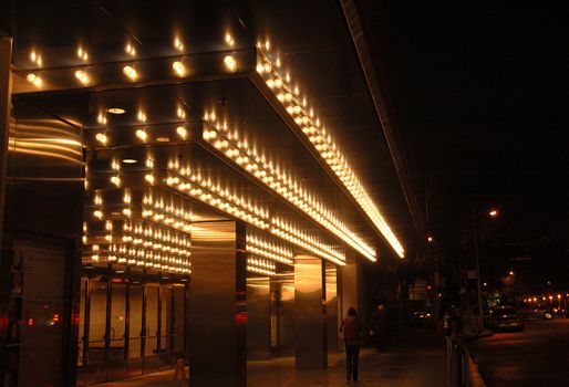 San Francisco opera house entrance illuminated at night.with a reflection after a rain