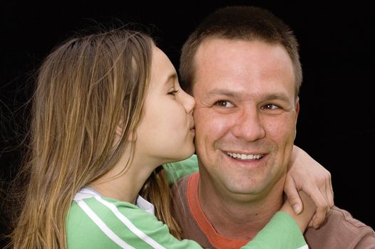 cute caucasian american girl kising father on cheek