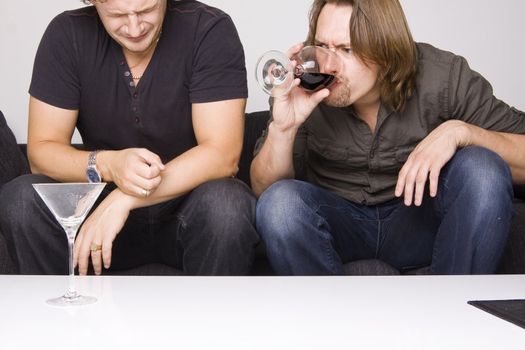 two friends drinking at home (grimacing)