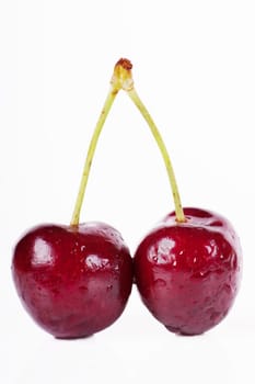 Close up view of pair of cherries isolated over white background