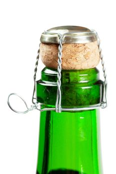 Close-up view of champagne bottle with cork isolated over white