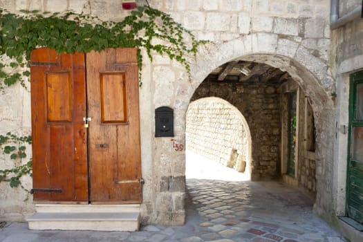 Wooden brown door and ole gate to fortification. Kotor - Montenegro