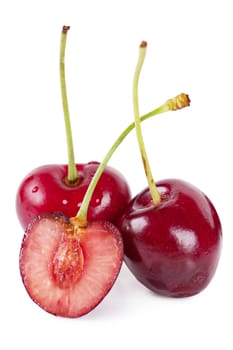 Close up view of three cherries over white background