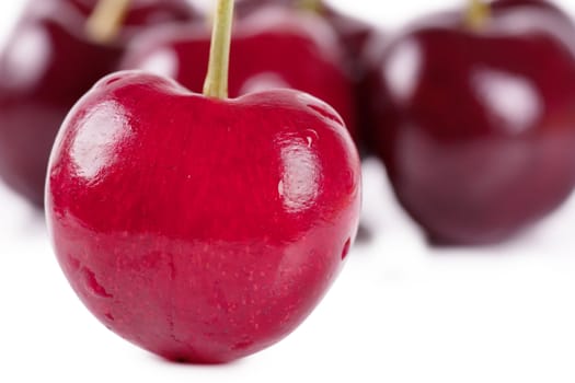 Close up view of heart shaped cherry and some cherries on background
