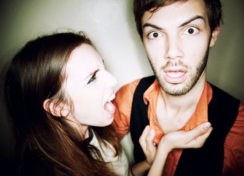 Young woman screaming at hapless bearded man