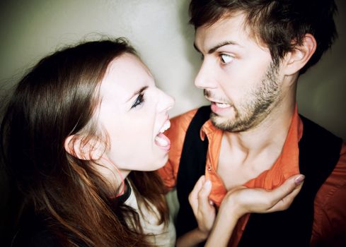 Young woman screaming at hapless bearded man