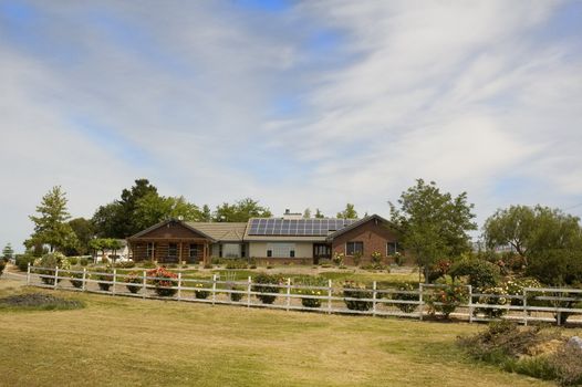 Solar powered home in the country using banks of photo voltaic cells on the roof to provide alternate energy.