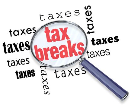 A magnifying glass hovering over the word tax breaks, symbolizing the advice and tricks that an accountant can use to increase deductions and save money when filing tax returns