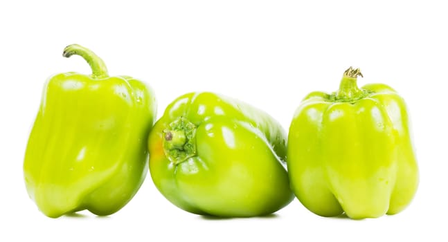 Three sweet green peppers isolated over white background