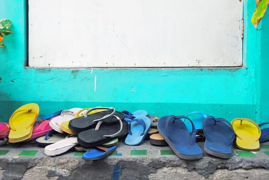 Slippers of visitors in front of white door