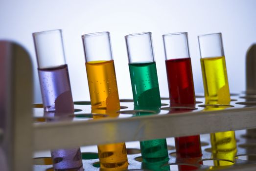 A line of test tubes containing different colored liquids