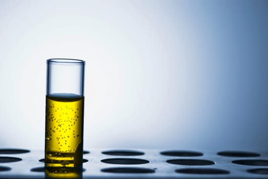 Single test tube with yellow liquid; studio shot
