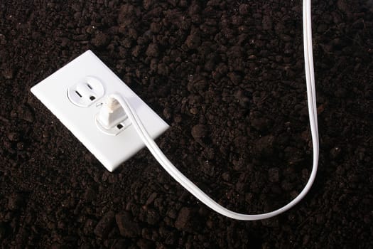 The electric socket against a ground - a symbol of an alternative energy source.