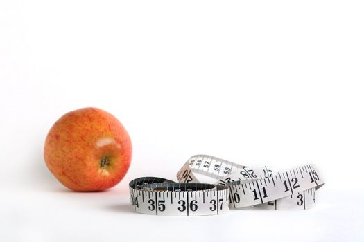 Tape measure and an apple characterise diet possibility.