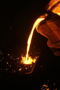 A metal casting into a form on a foundry